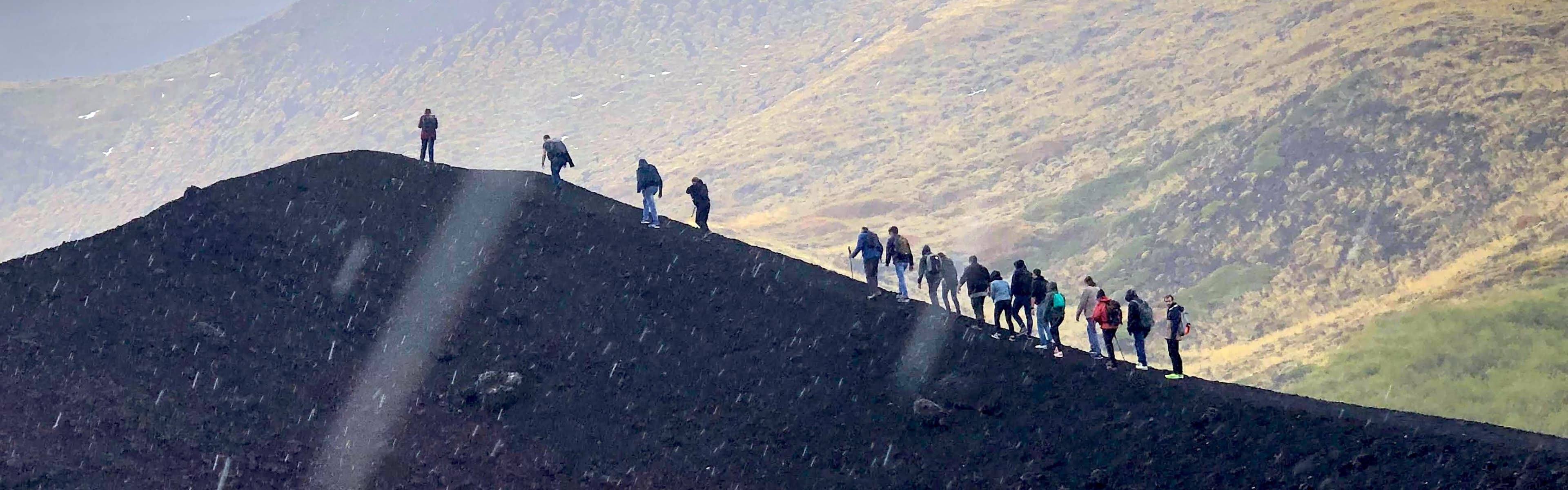 Talarian team gathered in front of a volcano during the annual offsite
